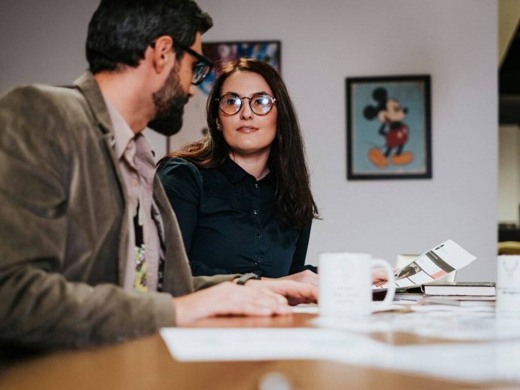 Married couple comparing joint vs. separate revocable trusts with an estate-planning attorney